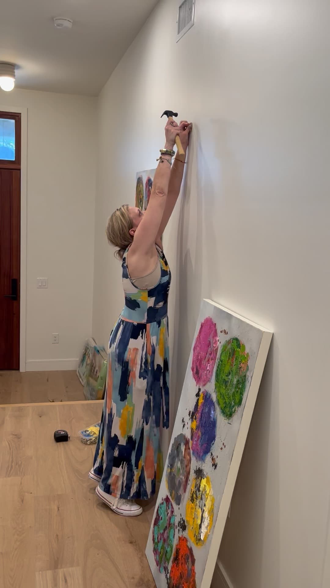 Artist hanging original artwork