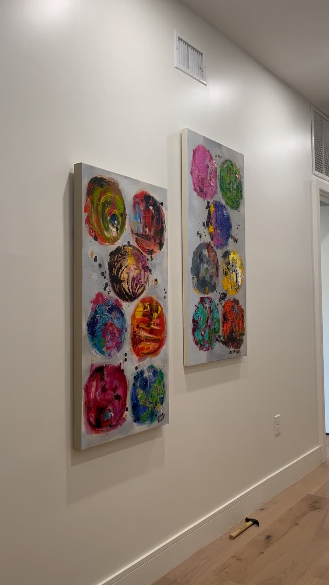 Artwork being installed in the showroom